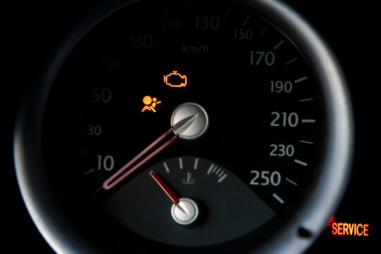 Car dashboard illuminating engine and airbag warning lights, indicating a vehicle malfunction and requiring immediate service for diagnosis and repair
