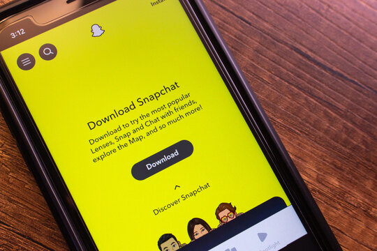 Mexico City, MEXICO - Sep 21 2025 : Close-up of a smartphone displaying the official Snapchat website with bright yellow branding and install prompt visible.