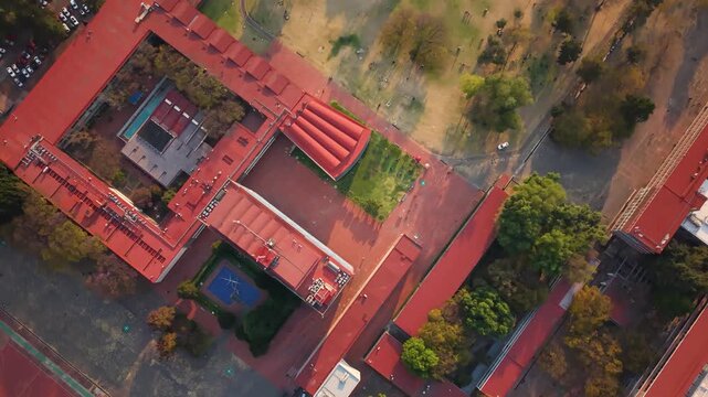 Sunny day drone shot over campus buildings in Mexico City