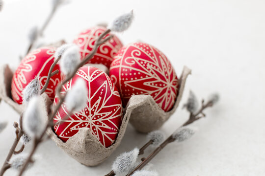 Red traditional hand written Easter eggs with catkin