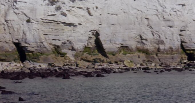 wide panning shot of the white cliffs of Dover at sapphire hoe Country Park sea