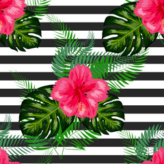 Hibiscus flowers and monstera leaves seamless pattern over black and white striped backdrop © Aziz