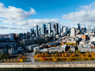 Fototapeta premium Aerial view of Montreal Old Port, downtown, historic buildings and waterfront under blue sky. g.