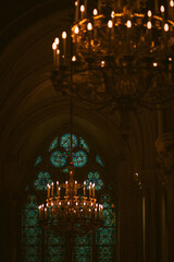 Chandeliers and Stained Glass in Gothic Cathedral Interior