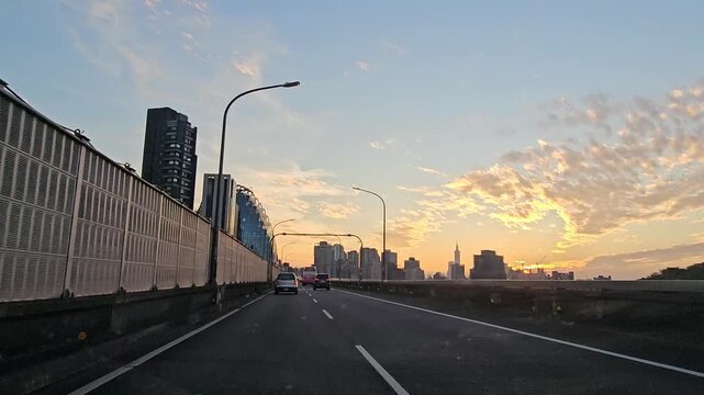 Taipei City, Taiwan - December 20 2025. Driving on Taipei&rsquo;s fast road toward Xindian as an airplane crosses the sky, set against sunset clouds and a glowing blue horizon for a serene cinematic travel 