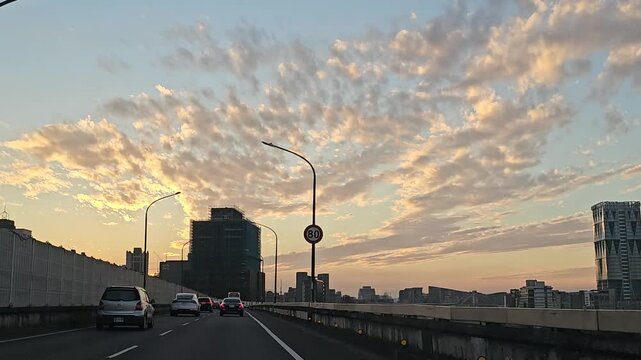 Taipei City, Taiwan - December 20 2025. Driving on Taipei&rsquo;s fast road toward Xindian as an airplane crosses the sky, set against sunset clouds and a glowing blue horizon for a serene cinematic travel 