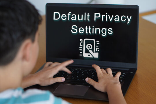 default privacy settings. Minors, social media. teenager looking at text projected onto a laptop screen.