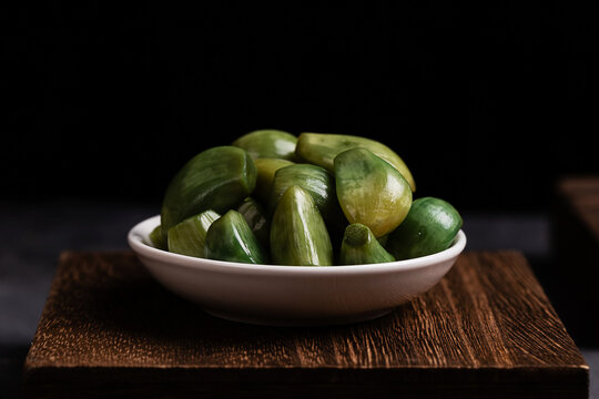 Fresh Green Cucumbers in White Bowl on Wood