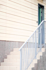 Fototapeta premium Stairs at the entrance to the house. Vertical photograph.