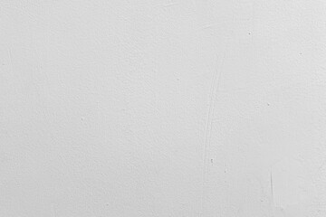 Bright white painted stucco wall with rough grainy texture and minor imperfections background