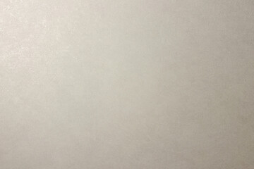 Fototapeta premium Delicate luminous off white light cream granular textured background pattern surface material