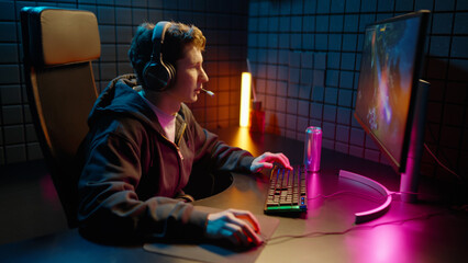 Young teen streamer gamer man play win online video game computer. Esport concept victory virtual entertainment. Cyber e sport videogame tournament live stream. Neon light. Tense winner competition. © Татьяна Епанешникова