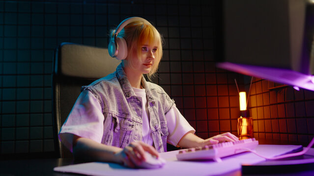 Young teen streamer gamer woman playing online video game on computer. Esport concept gaming virtual entertainment. E sport videogame tournament live stream. Tense female player cool girl competition.
