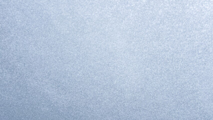 Fototapeta premium Glistening light blue grainy surface background with small shimmering shiny glitter particles