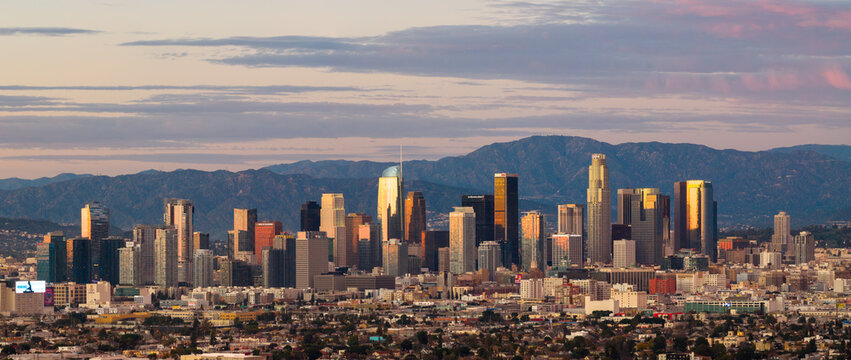 Aerial Panorama of Down Town LA at sunset with mountains behind