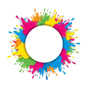Vibrant paint splatters forming a circular frame around a blank space viewed from directly above