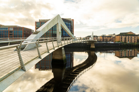 Squiggly Bridge in Glasgow reflecting on Clyde River on a sunny autumn day