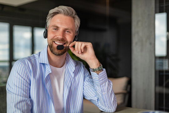 Businessman wearing headset working in home to support remote customer or colleague
