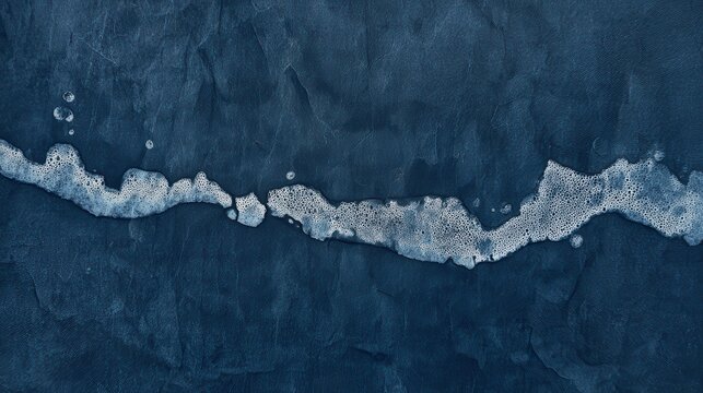 Dried water damage on dark blue paper, tidal lines and salt deposits, distressed texture