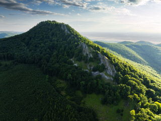 Mountain landscape with rocks, cross on top of mountain, sunlit hills. Picturesque landscape of Male (Little) Karpaty, Slovakia, Slovakia mountain range. © TTstudio