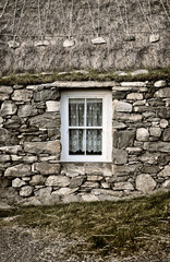 Blackhouse Village. Restored crofting village of Garenin, Na Gearrannan, in NW Lewis.  Lived in till 1974. Croft sash window and thatched roof © David Matthew Lyons