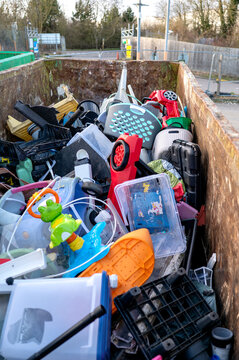 Large recycling container filled with plastic household waste.