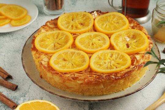 The orange phyllo cake Portokalopita, served in light rustic style	