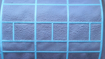 Close-up of textured blue filter with grid pattern for air conditioning unit
