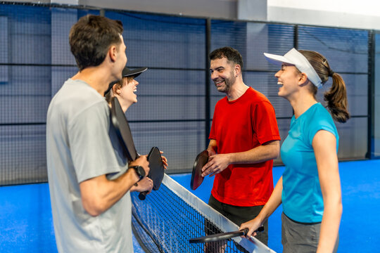 Friends laughing and talking after playing pickleball