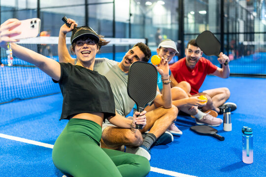 Friends playing pickleball taking selfie on court