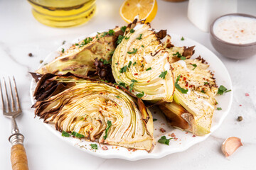 Roasted baked cabbage with cheese and aromatic herbs