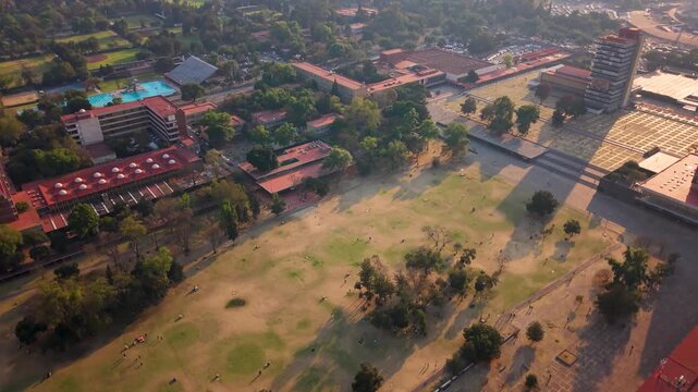 Drone view of a university campus with green areas on a sunny afternoon in Mexico City