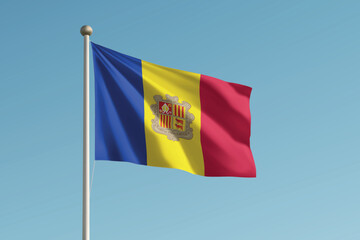 Andorra national flag waving on pole against clear blue sky background.