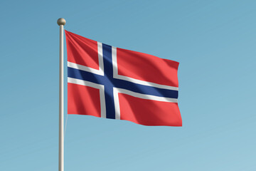Norway national flag waving on pole against clear blue sky background.