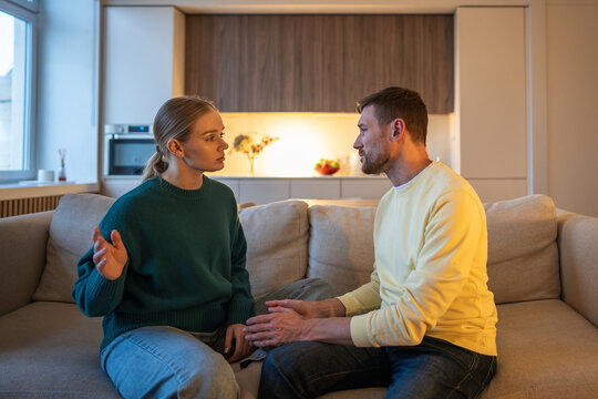 Frustrated wife fed up with manipulative lies about cheating affair from guilty husband, couple having argument at home, marriage crisis and toxic relationships, family in quarrel over betrayal.