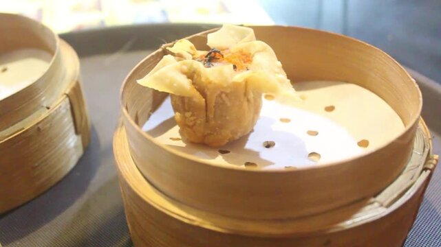 Fried dim sum prepared in a bamboo container