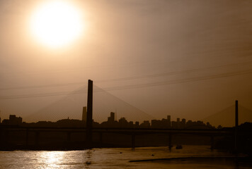 Obraz premium The silhouettes of city skyline under the sunlight during the sunset in Chongqing, China