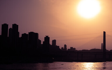 The silhouettes of city skyline  under the sunlight during the sunset in Chongqing, China