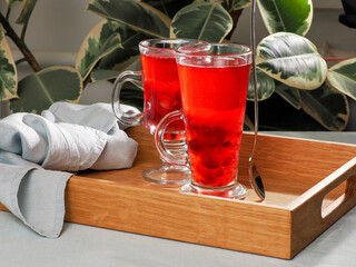 Two Glasses of Red Berry Drink on Wooden Tray. Antioxidant rich cranberry beverage in glasses. Healthy organic red berry juice for a balanced diet. Cold berry infusion detox drink © fascinadora