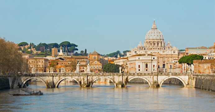 Rome - Angels bridge and St. Peter s basilica in morning with the flood on the Tiber.