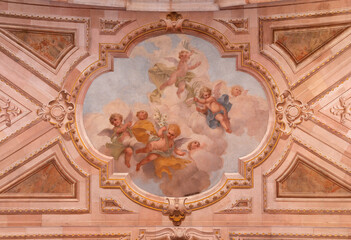 Naklejka premium BUSTO ARSIZIO, ITALY - JANUARY 19, 2026: The fresco of angels with symbols of martyrdom in the church Basilica di San GIovanni Battista by Carlo Grossi (1907)