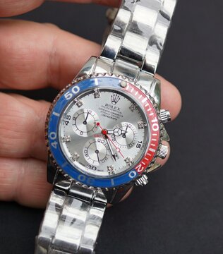 Hand holding Rolex Oyster Perpetual Cosmograph Daytona watch