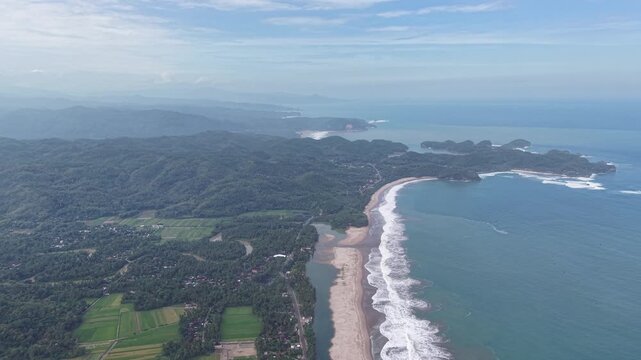 Aerial View of Pacitan Coastline and Beaches With Lush Hills and Waves Crashing on Shore