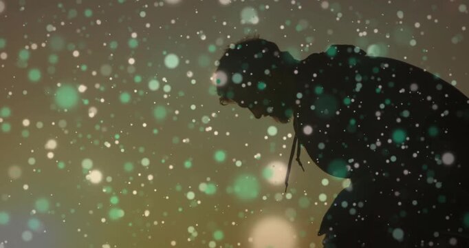 Male silhouette bending in warm glow, bokeh drifting over hood cords, responding to halo for tech