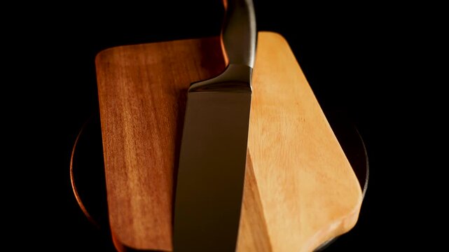 Sharp knife on wooden cutting board in close-up shot for kitchen preparation tasks