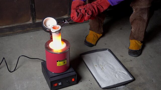Crucible removed from furnace, molten borax is poured out into tray of sand, and crucible replaced in furnace.