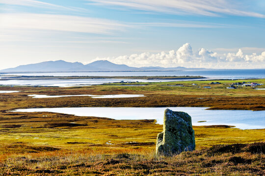 Prehistoric standing stone just south of South Clettraval Chambered Tomb, North Uist, Outer Hebrides. View S over Kirkibost to Beinn Mhor on S. Uist