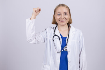 Fototapeta premium Female doctor celebrating success with fist up