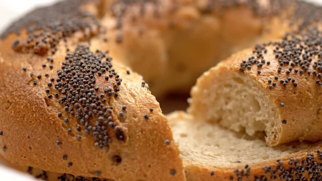 Close up of a freshly baked poppy seed bread loaf with a slice cut out.