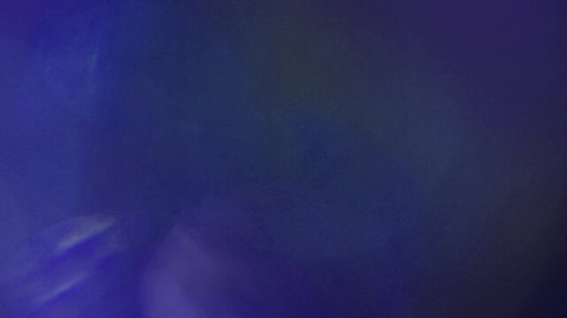 Light leak and bokeh overlay with purple and blue hues, perfect for adding artistic flair to video projects. This footage is ideal for transitions, mood setting, or atmospheric effects.